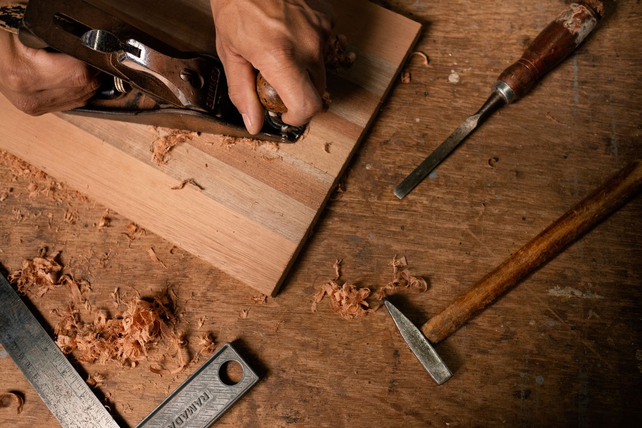 Craftsman shaping solid wood in the Boreal Woodworks studio