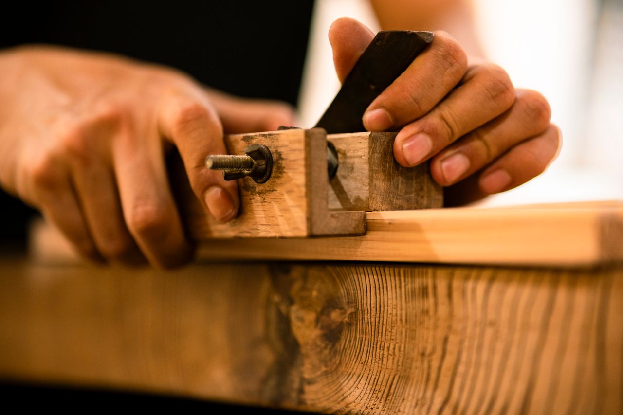 Craftsman working on a wooden dining table